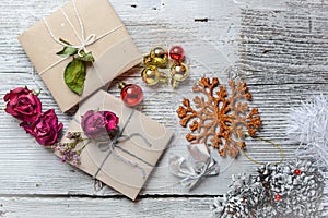 Two small gifts wrapped in ecologic paper, old wooden white table