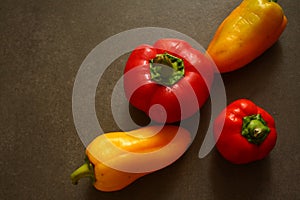 two small red and two yellow sweet peppers