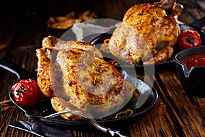 Two small roasted poussin or spring chickens photo