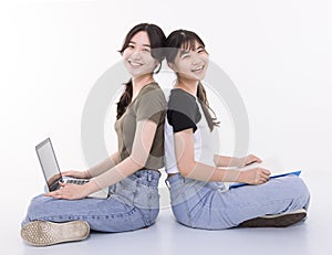 Two smart teenager student girls sitting together