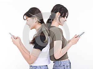 Two smart teenager student girls watching the smart phone