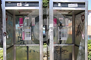 Two smeared public phone booths