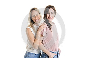 Two smiling best girl friends blond and brunette on white background. Closeup face portrait of two young beautiful women