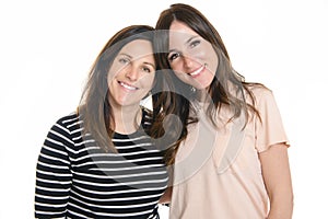 Two smiling best girl friends brunette on white background. Closeup face portrait of two young beautiful women.