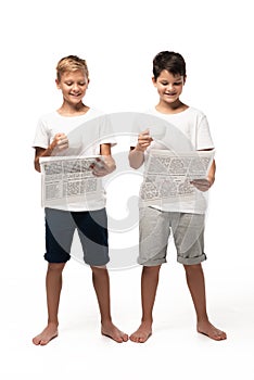 Two smiling brothers reading newspapers while holding coffee cups
