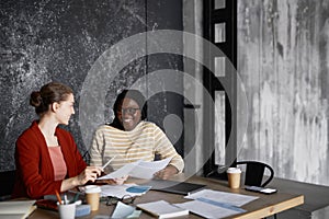 Two Smiling Businesswomen Meeting in Office