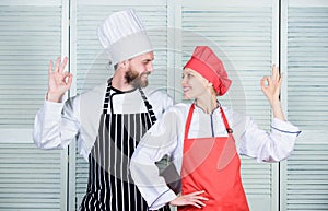 Two smiling chefs in kitchen. couple in love with perfect food. man and woman chef in restaurant. secret ingredient by