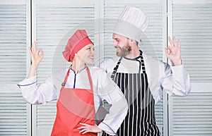 Two smiling chefs in kitchen. couple in love with perfect food. man and woman chef in restaurant. secret ingredient by