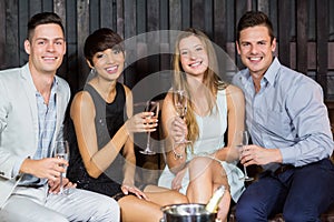 Two smiling couple having glasses of champagne