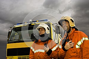Two smiling firemen