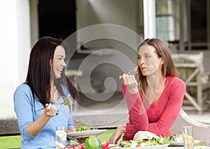 Two smiling friends enjoying lunch