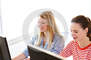 Two smiling girls in computer class