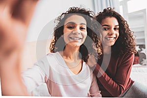 Two smiling girls feeling good taking pictures