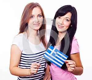 Two smiling girls with greek flag.