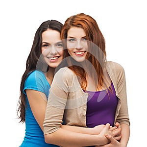 Two smiling girls hugging