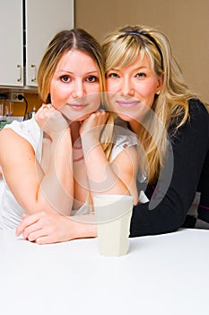 Two smiling girls in the kitchen