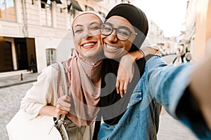Two smiling mid aged islamic women