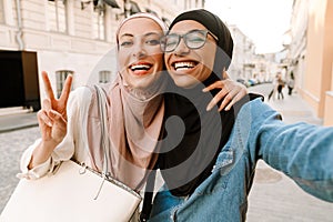 Two smiling mid aged islamic women