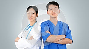 Two smiling physicians in uniform, concept of clinic staff teamwork