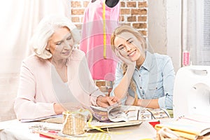 Two smiling seamstresses