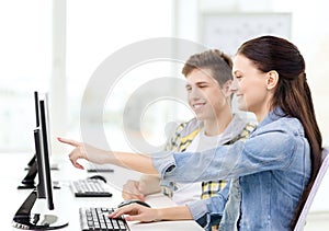 Two smiling students in computer class