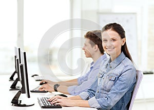Two smiling students in computer class