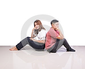 Two smiling woman young girls and happiness tomboy friends sitting back to back on floor with white background