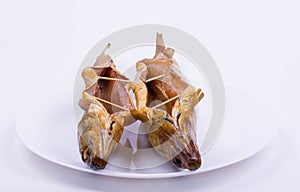 Two smoked baikal omul on a white plate