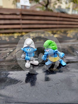 Wild Smurf and Hefty Smurf Figurines Outdoors