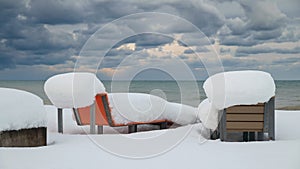 Two snow covered benches