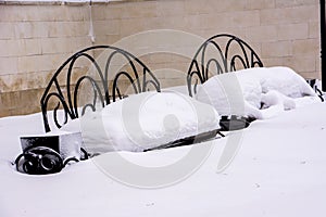 Two snow-covered benches