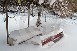 Two snow covered benches