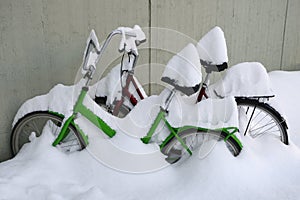 two snow covered bikes in winter