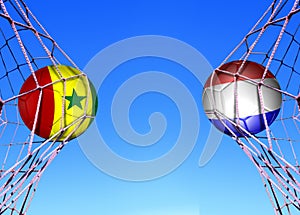 Two soccer balls in flags senegal  and Hlland