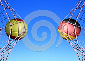 Two soccer balls in flags  Spain and Germany