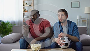 Two soccer fans watching american football match, trying to understand rules