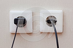 Two sockets with plugs inside