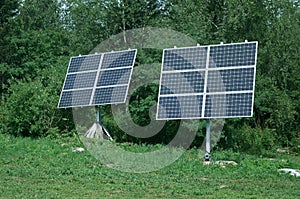 Two solar pannel in fores. Renewable energy and ecology