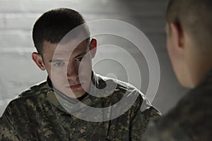 Two soldiers meeting in dark room, horizontal