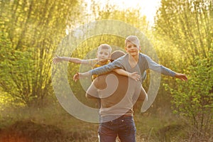 Two sons and his spring in winter forest, outdoor portrait. Father holding two sons. fun, joy, happiness, friendship