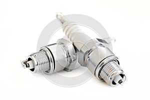 Two spark plugs on white