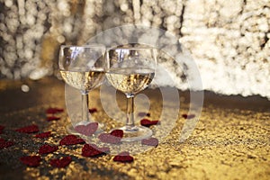 Two Sparkling White Wine in Glasses with Heart Confetti and Gold