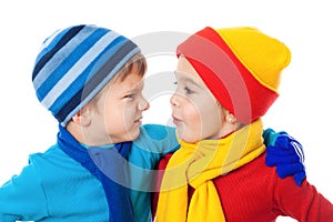 Two speaking kids in winter clothes