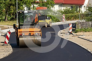 Two special autos paving new asphalt driving in line one near another