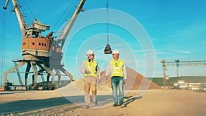 Two specialists are walking along the quarry site