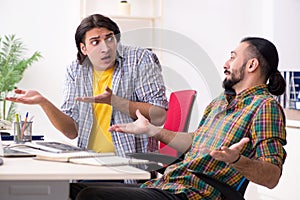 The two it specialists working in the office