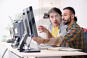 The two it specialists working in the office
