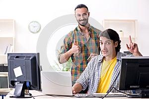 Two it specialists working in the office