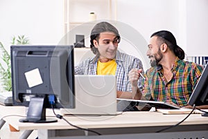 Two it specialists working in the office
