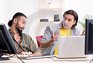 Two it specialists working in the office